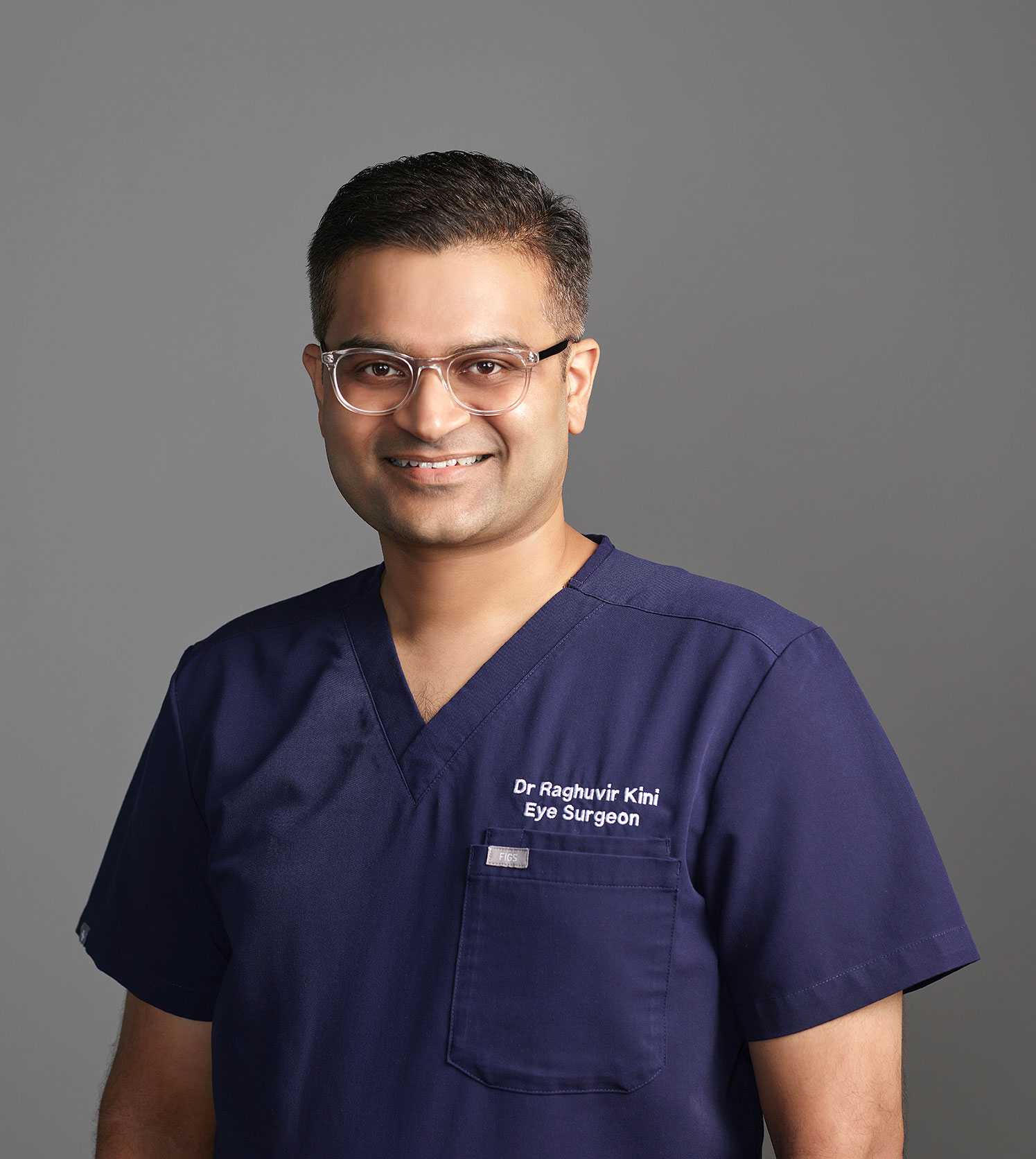 Dr Raghuvir Kini dressed in surgical scrubs